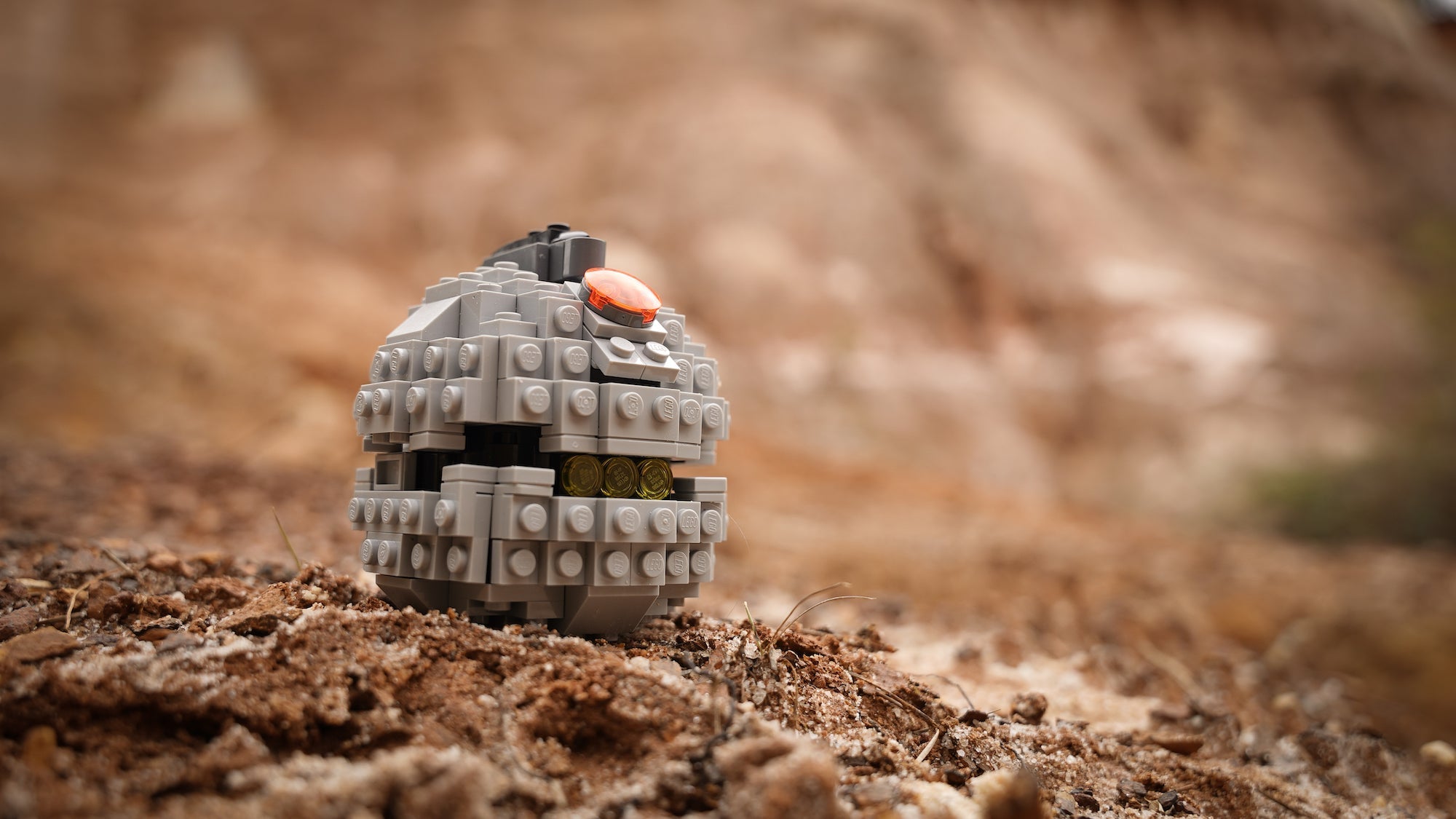 thermal detonator life sized replica built with lego bricks in desert sands