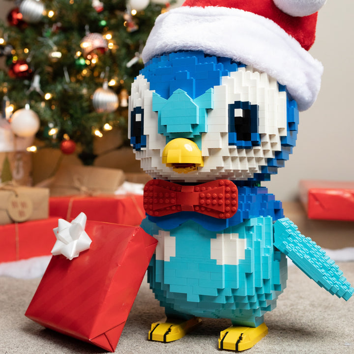 Proud Penguin with a Christmas Present wearing Santa Hats Life-Sized Sculptures built with LEGO® bricks - by Bricker Builds