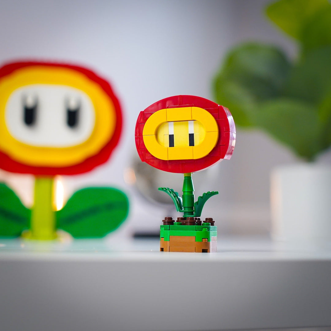 Mini Fire Flower made of LEGO® Bricks by Bricker Builds with life-sized Fire Flower blurred in the background