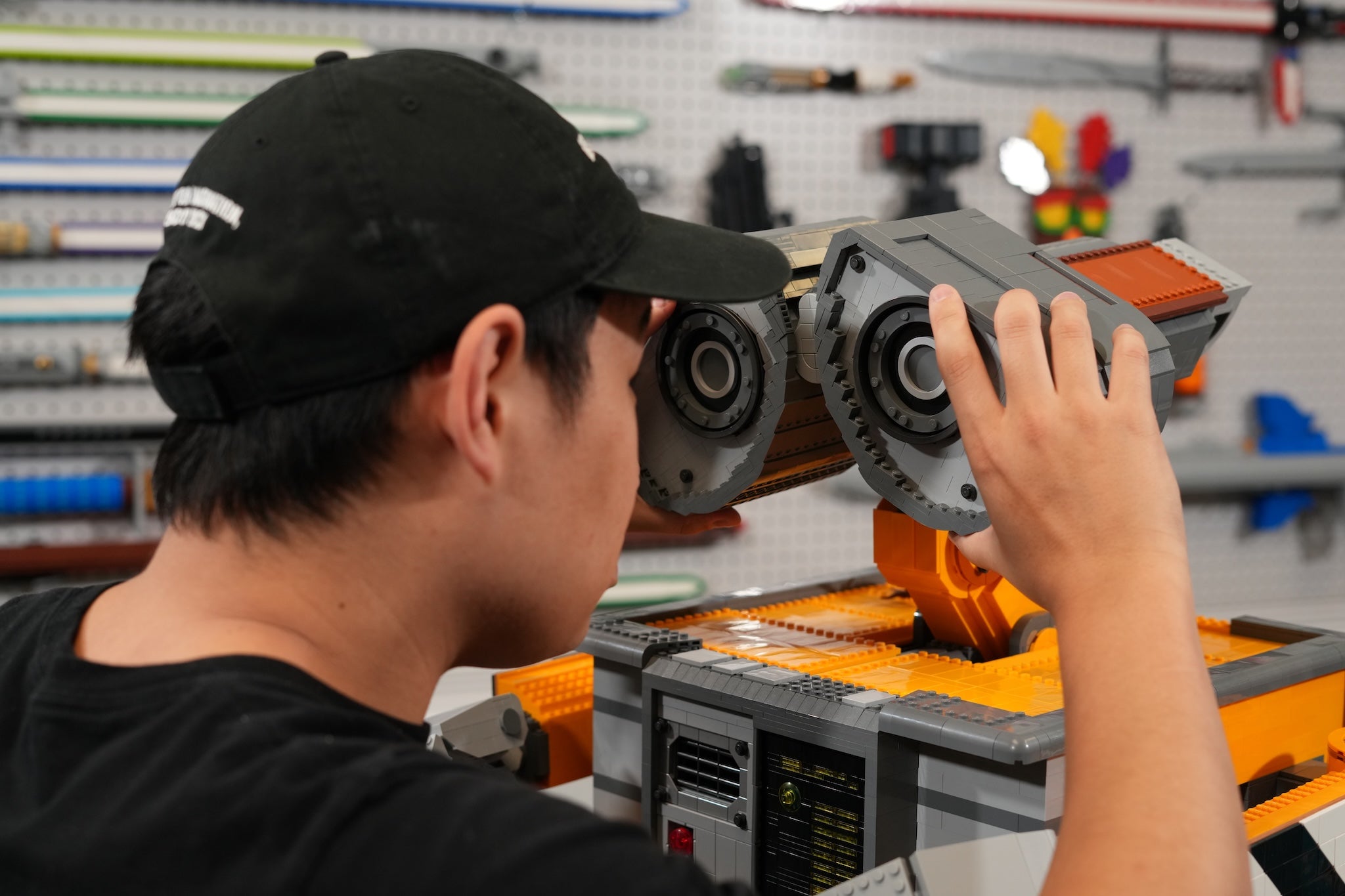 Bricker Builds designer working on a mechanical assembly of Scrap-E in a workshop setting