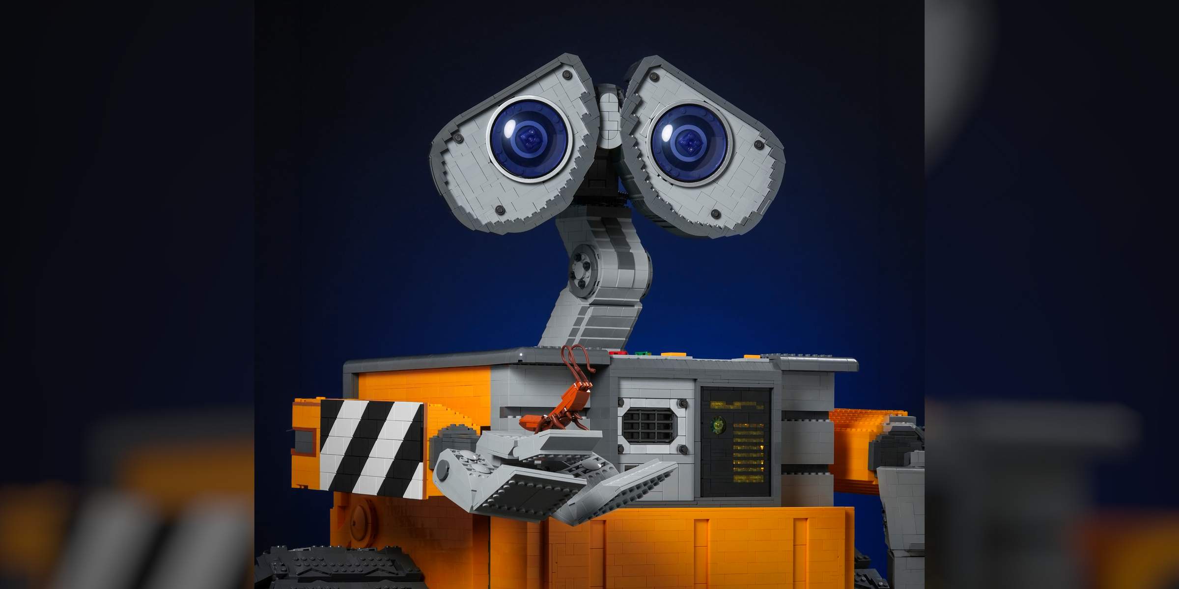 SCRAP-E premium LEGO® brick custom display model designed by Bricker Builds featuring articulated arms, movable head, opening compartment, and custom lighting.