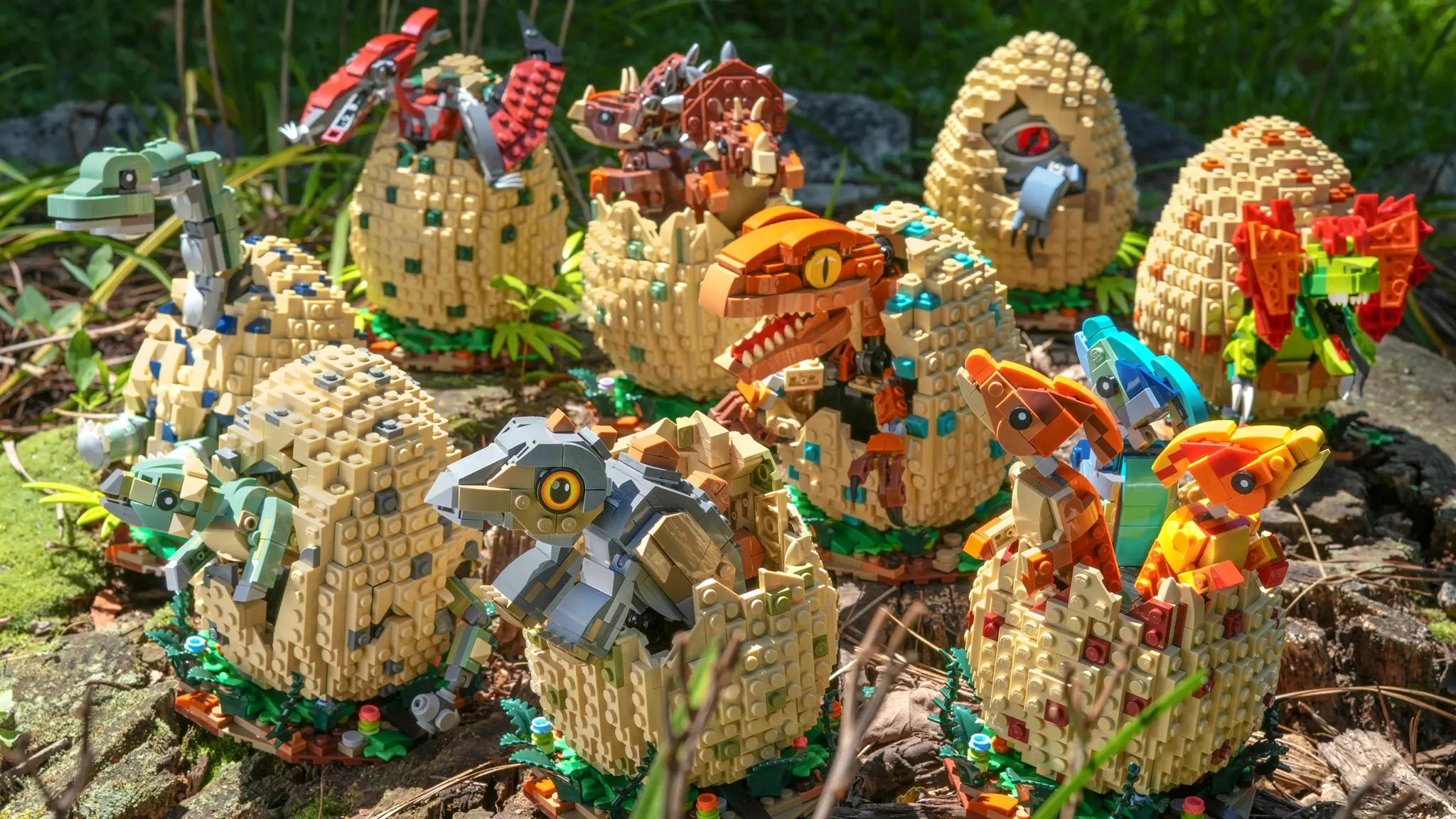 Collection of colorful brick built dinosaur baby creatures in egg-like enclosures on a natural background by Bricker Builds