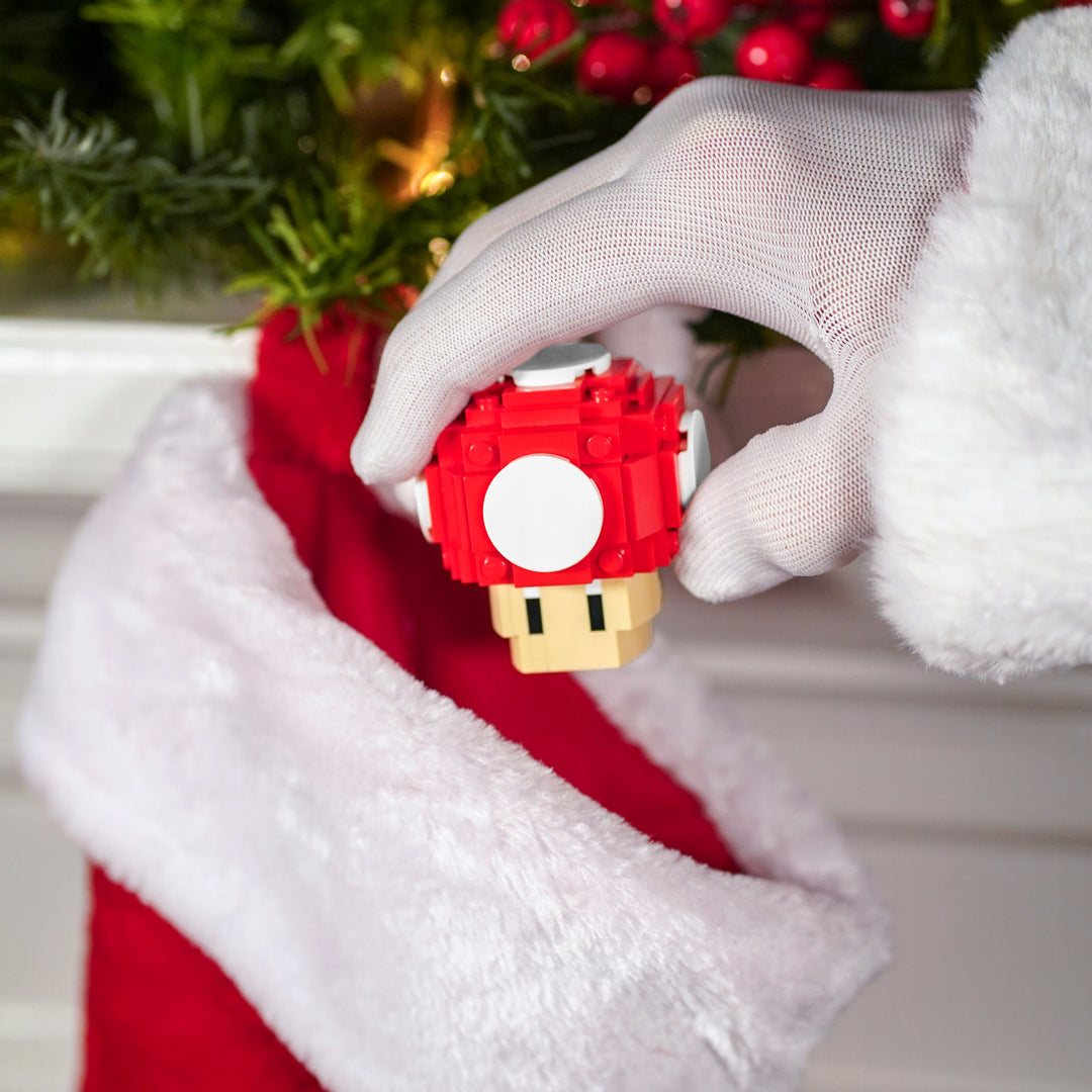 Mini Red Mushroom built with LEGO® bricks - by Bricker Builds being put in a stocking